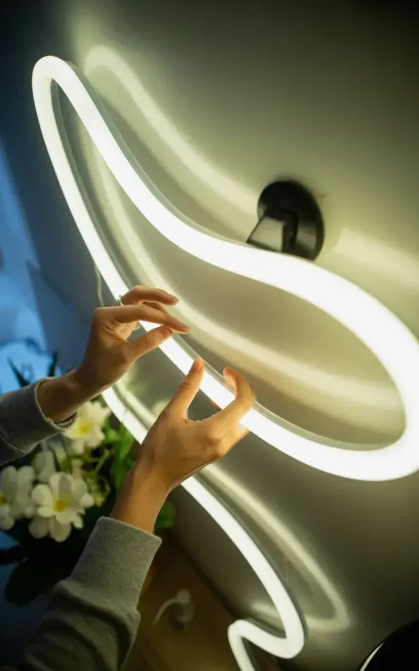 LED Neon Light Close-Up | White S-Curve Sign Against Gray Wall
