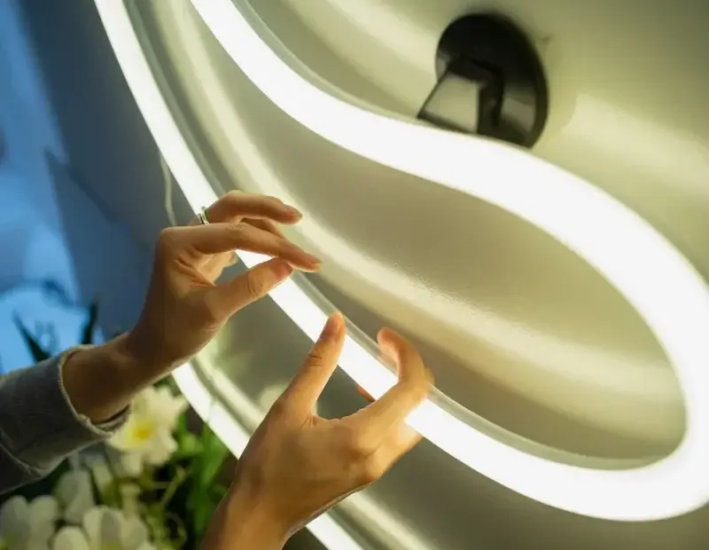 LED Neon Light Close-Up | White S-Curve Sign Against Gray Wall